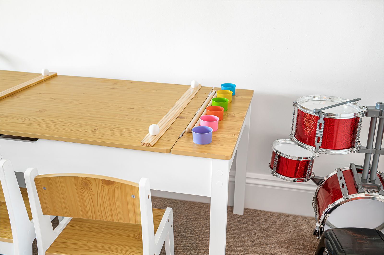 Kids art table with paints and drum kit